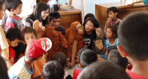 Young students watch a puppet show given by GPOCP